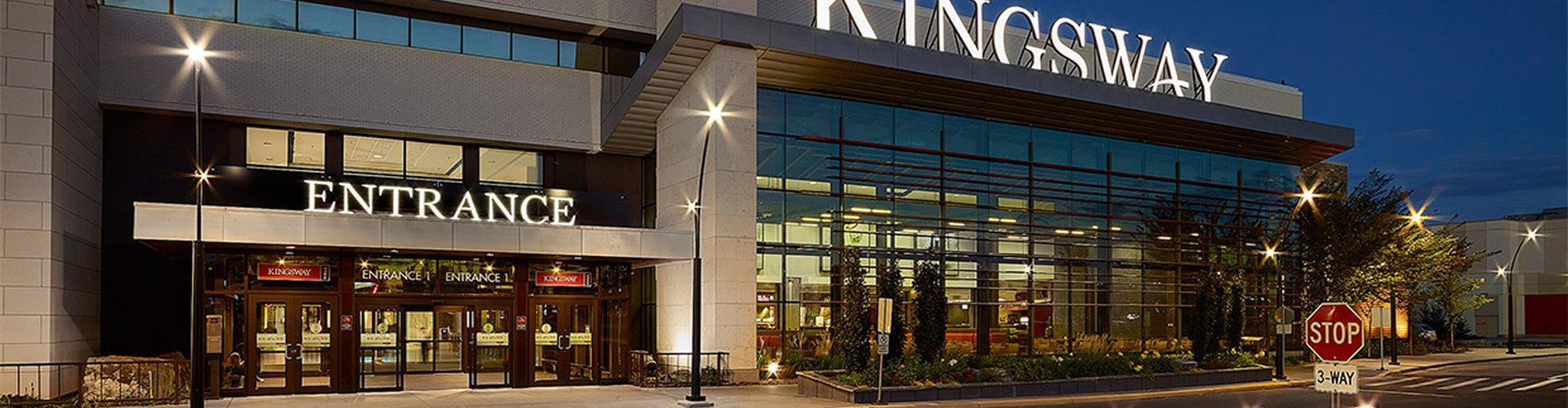 Illuminated Kingsway mall entrance and glass facade at night