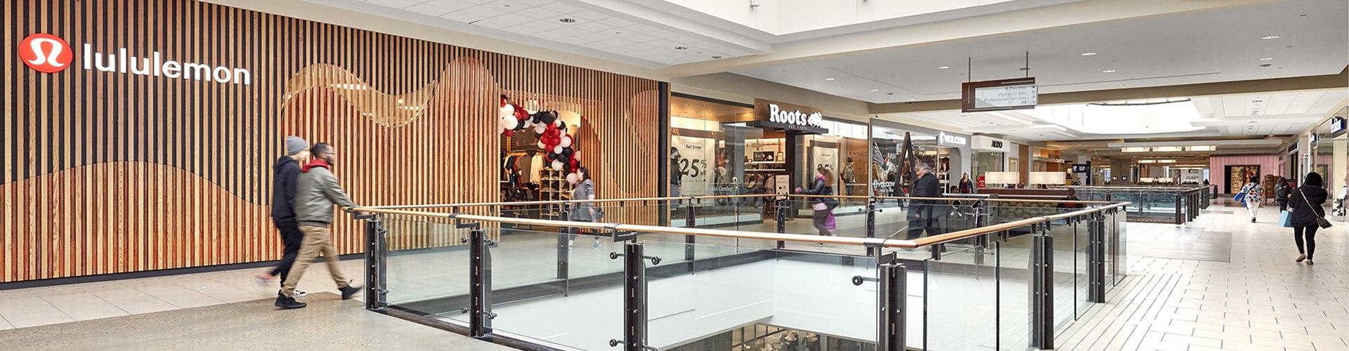 Upper-level mall walkway with lululemon and Roots storefronts