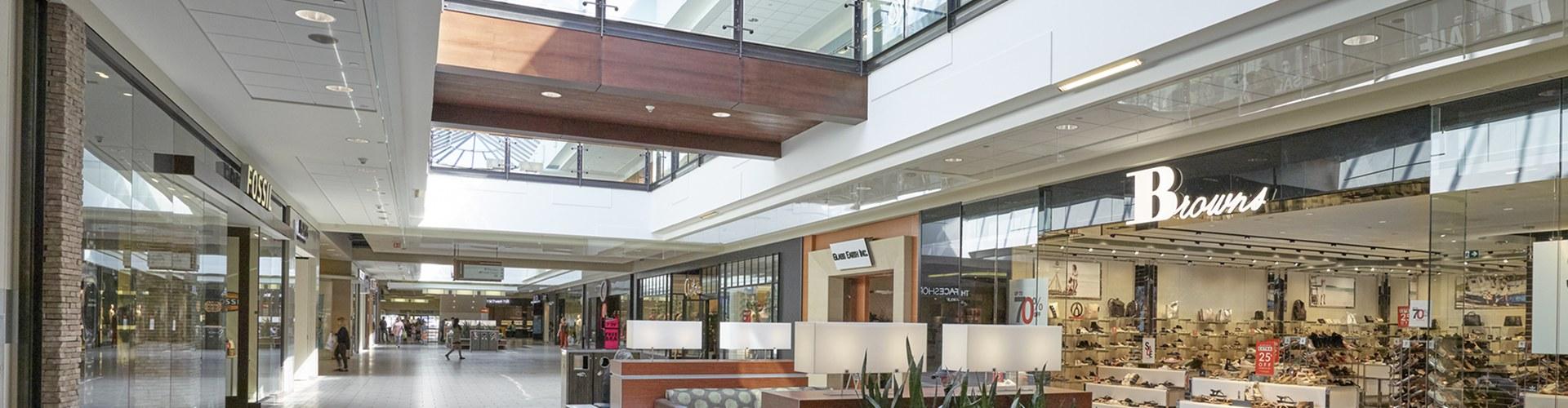 Bright mall concourse with Fossil and Browns shoe storefronts