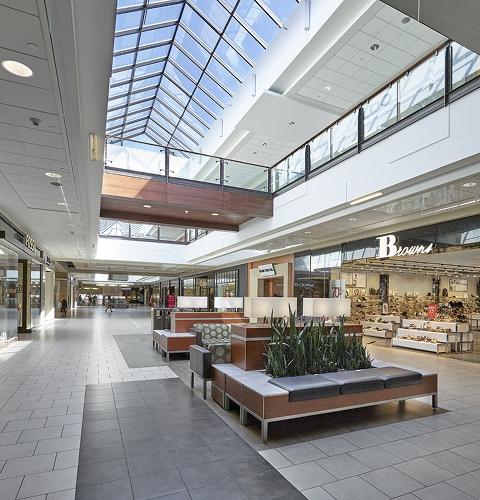 Bright mall concourse with Fossil and Browns shoe storefronts
