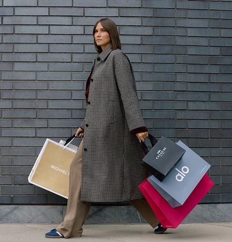 Shopper carrying multiple bags showcasing exclusive offers and retail variety at the shopping centre