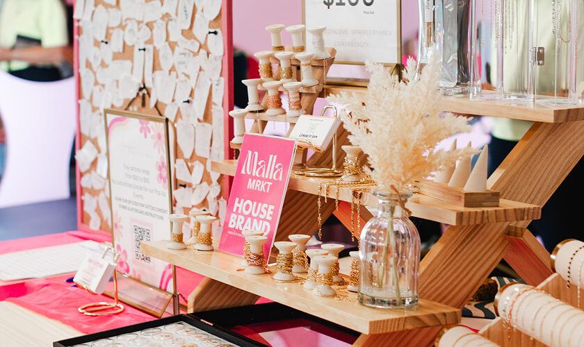 Malla Mrkt house brand jewellery displayed on a tiered wooden stand