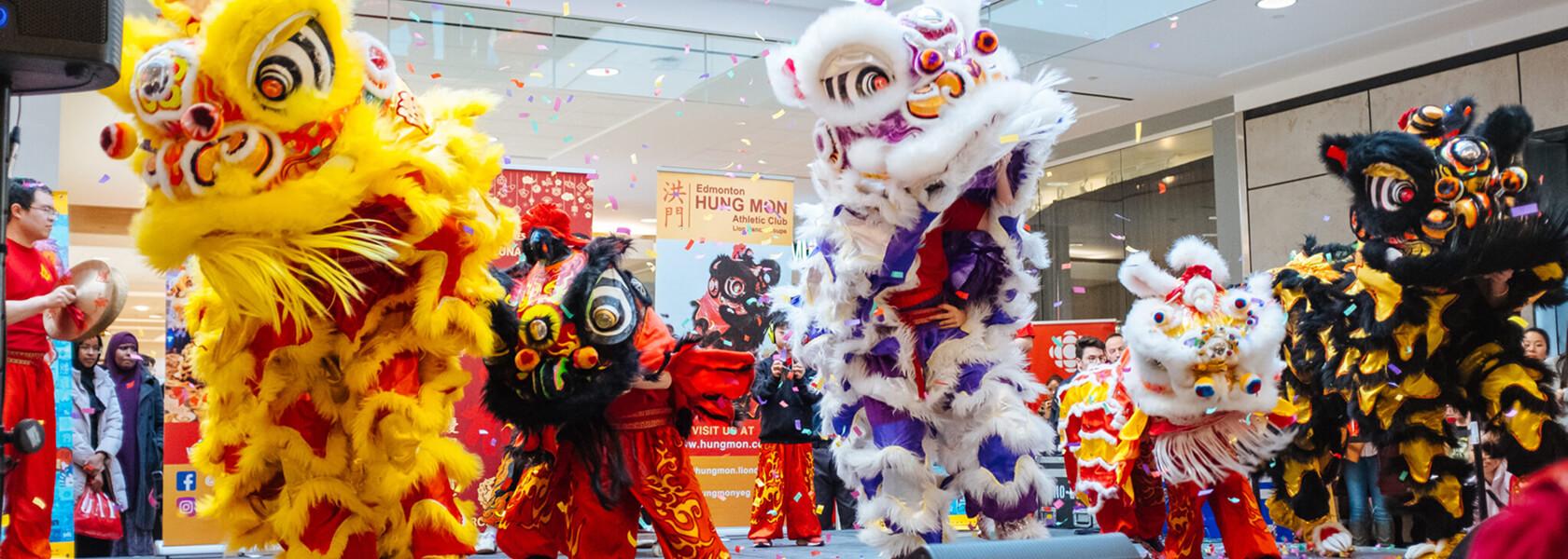 Colourful lion dance performers at a Lunar New Year celebration in the mall