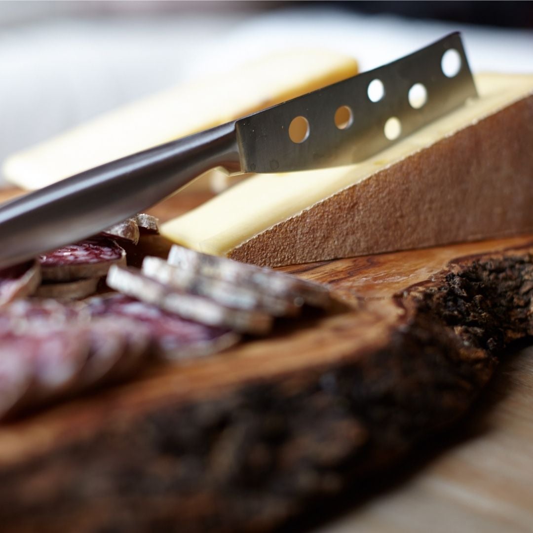 Cheese knife cutting a cheese