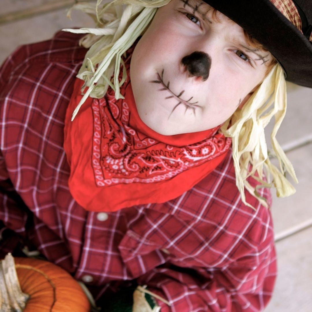 Kid dressed up as a scarecrow