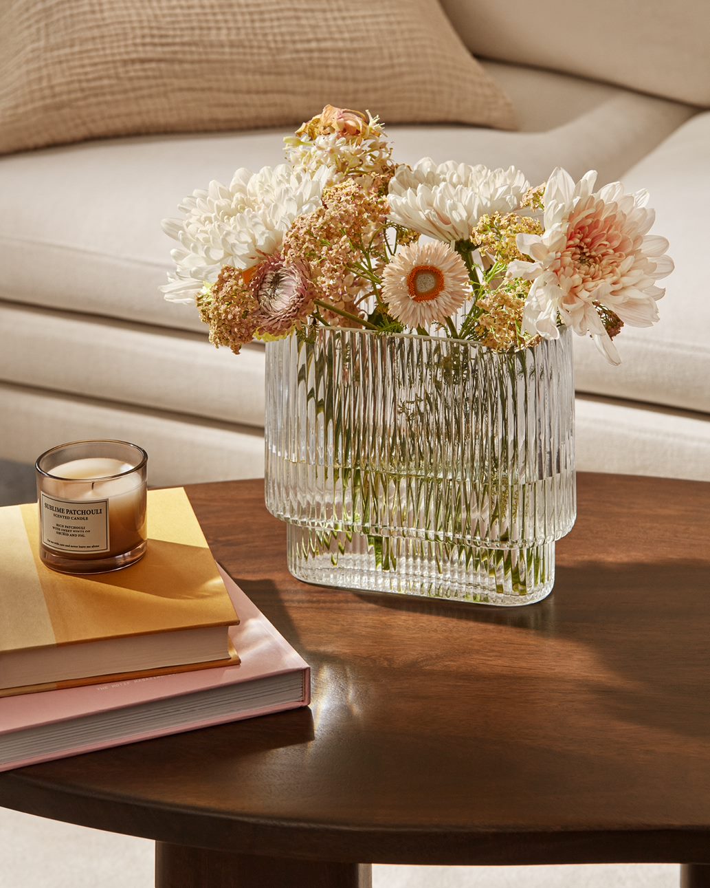 Neutral coloured flowers in a clear vase