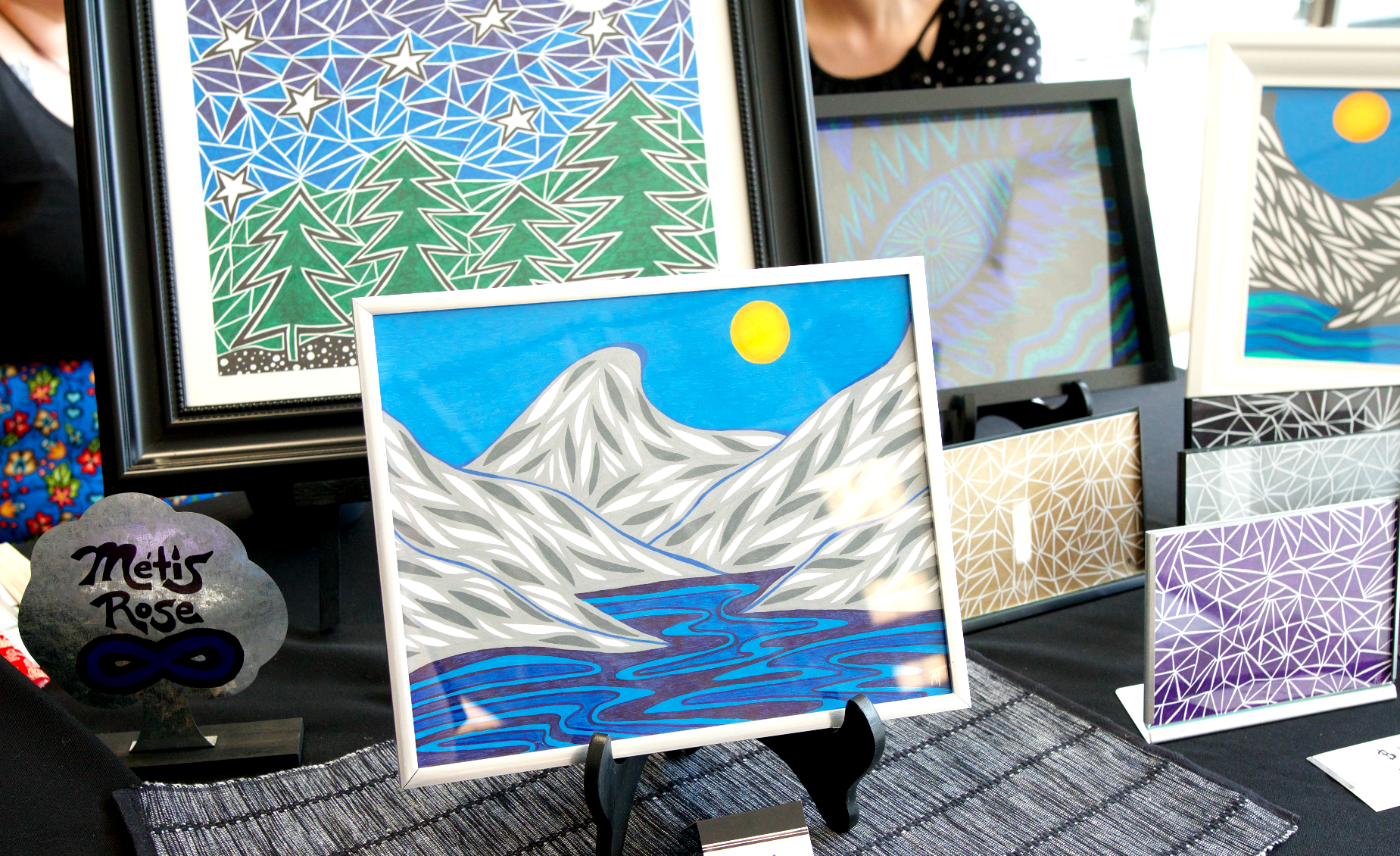 collection of Metis artwork displayed on canvases