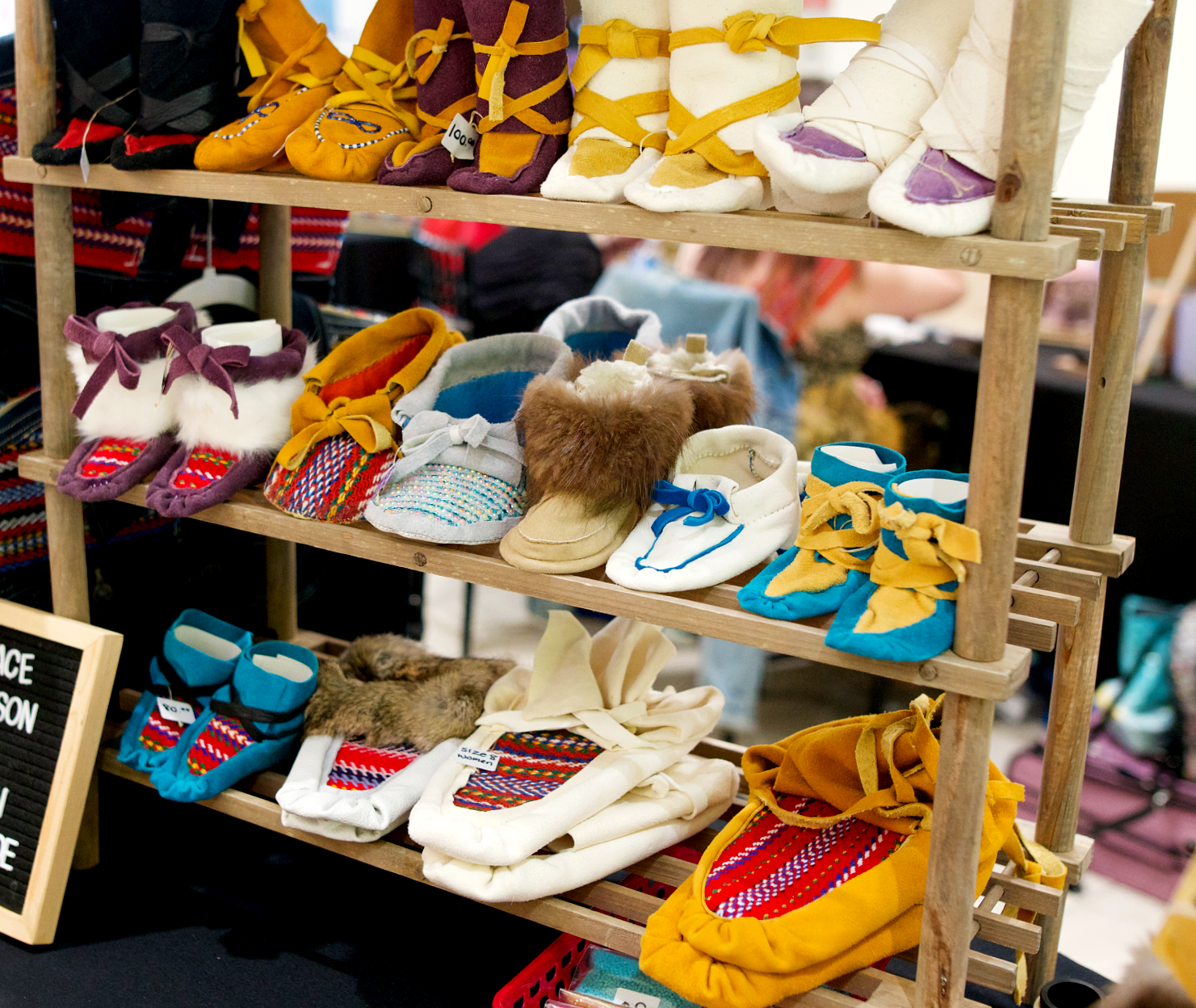 colorful moccasins on a shelf from a market vendor