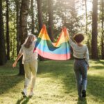 Two women holding a Pride flag