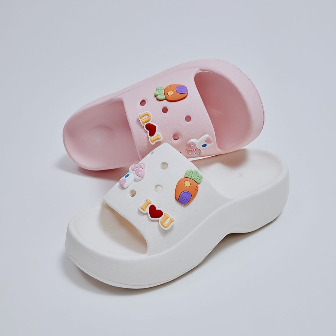 image of platform rubber sandals in pink and white with charms