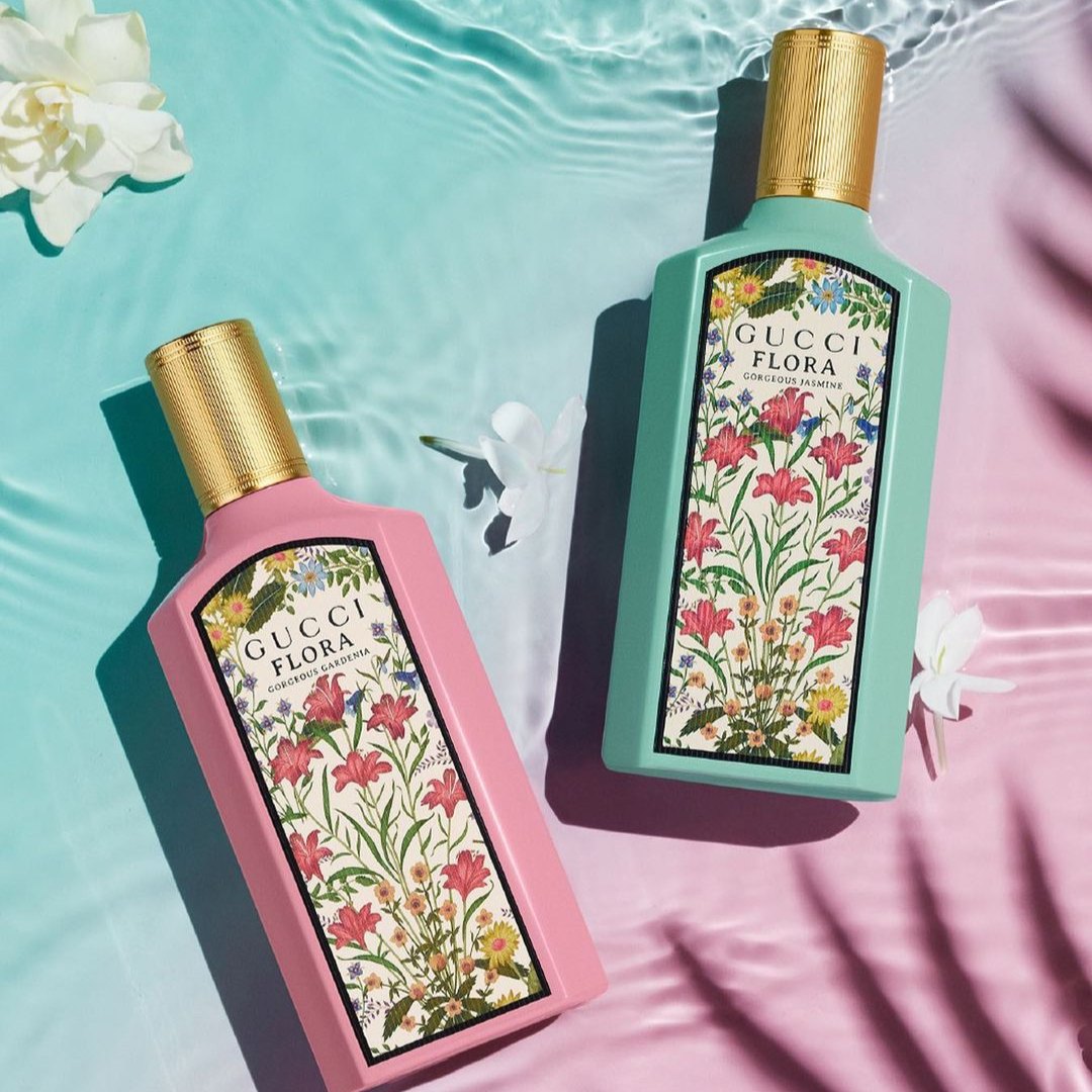 image of two gucci floral bottles -- one is pink and the other is green -- with gold caps