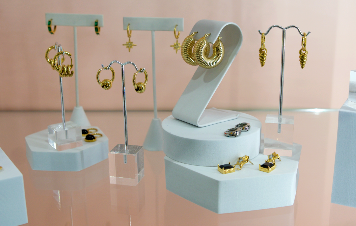 gold hoop and pendant earrings in case