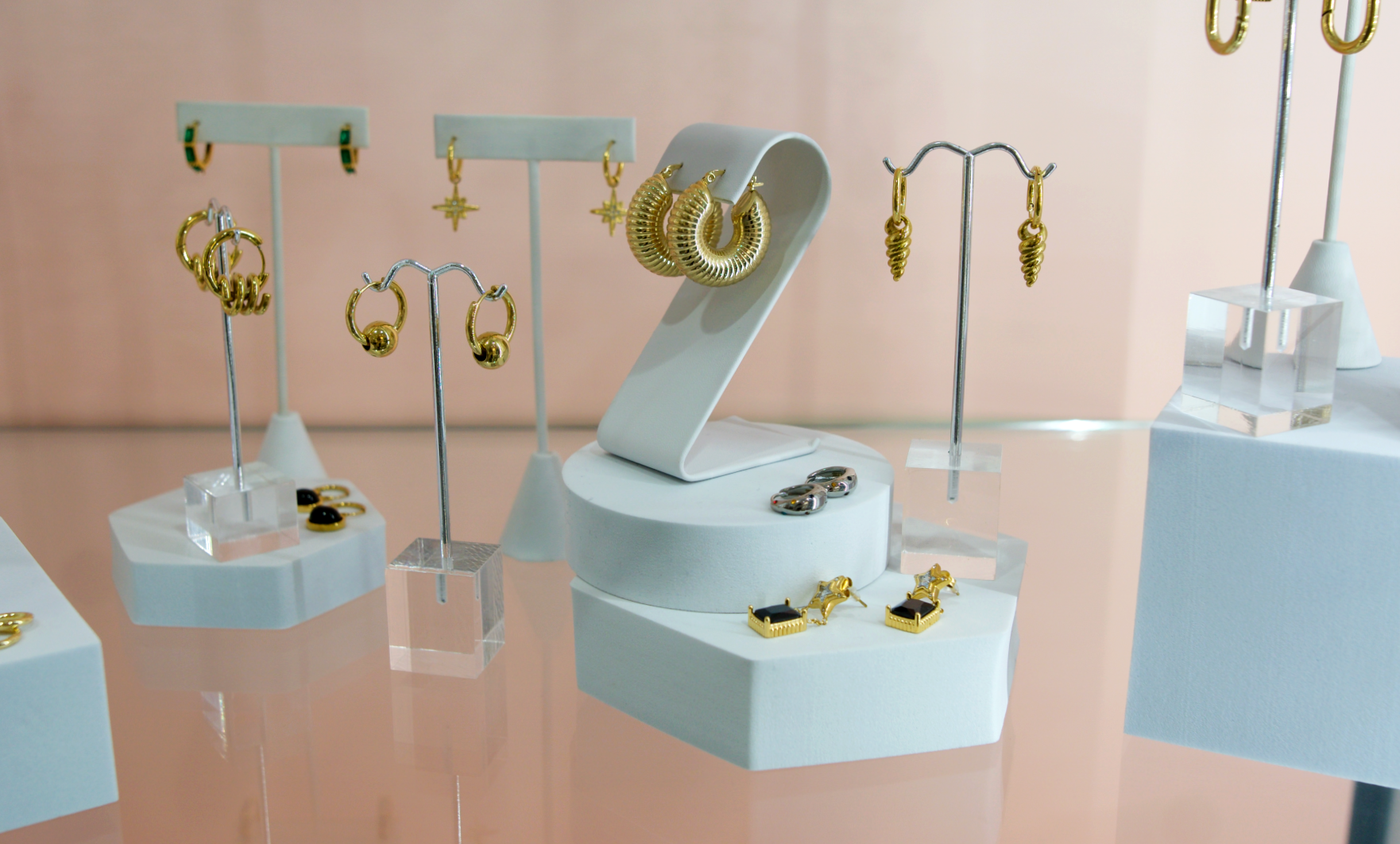 gold hoop and pendant earrings in case