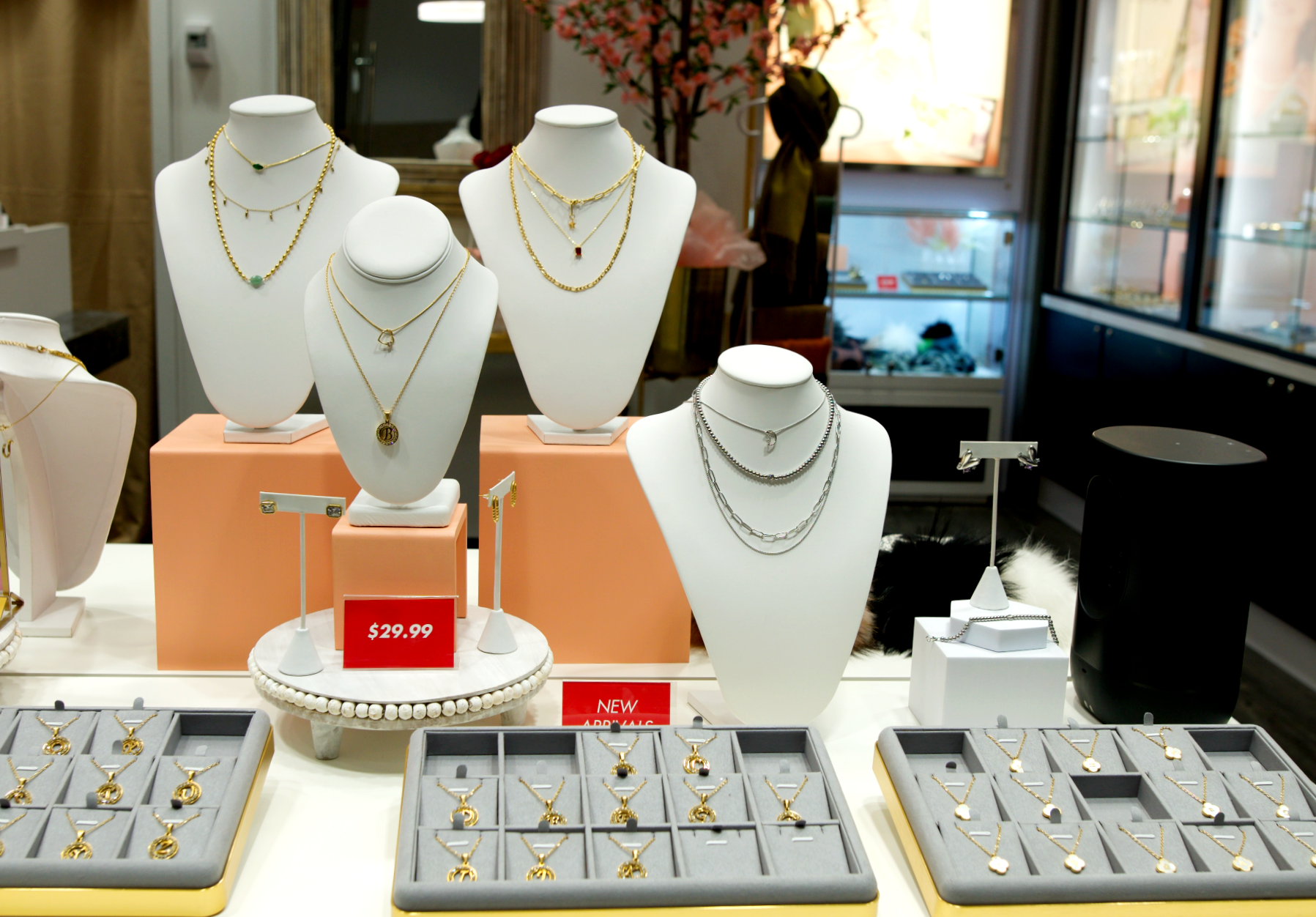 table display of gold and silver pendant necklaces