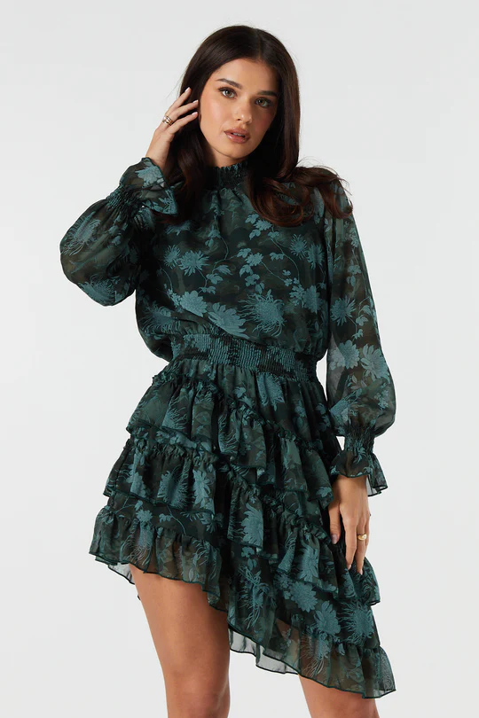 model wearing black and green dress with ruffles