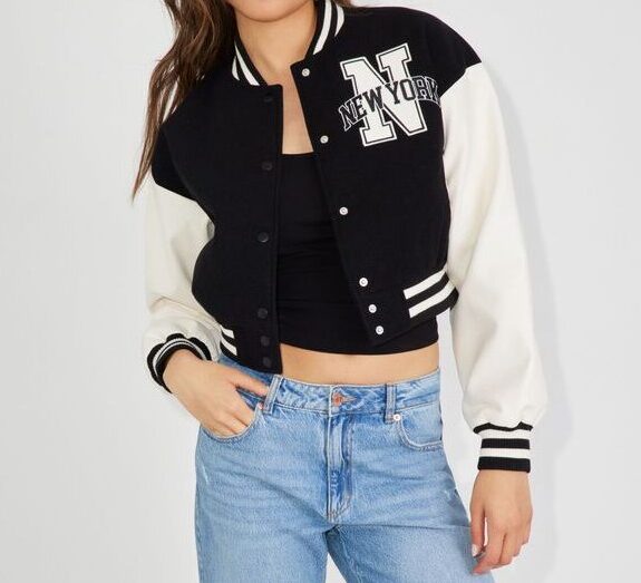 model wearing cropped varsity jacket