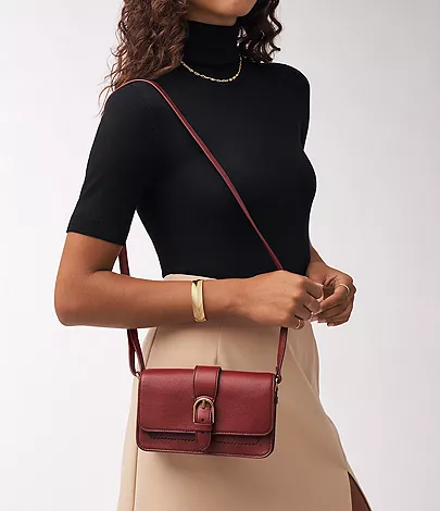model wearing fossil dark red purse