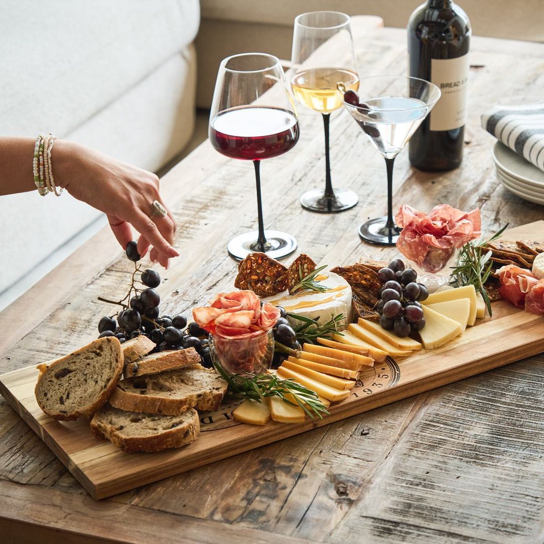 image of a charcuterie board spread with wine on a wooden table