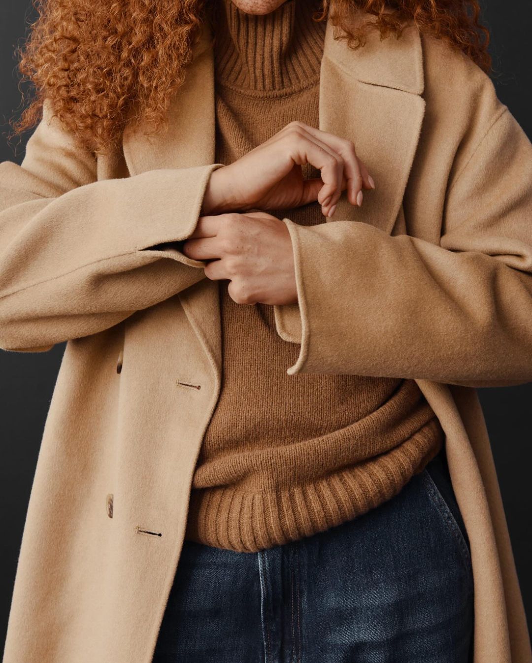 model wearing brown sweater with long brown peacoat