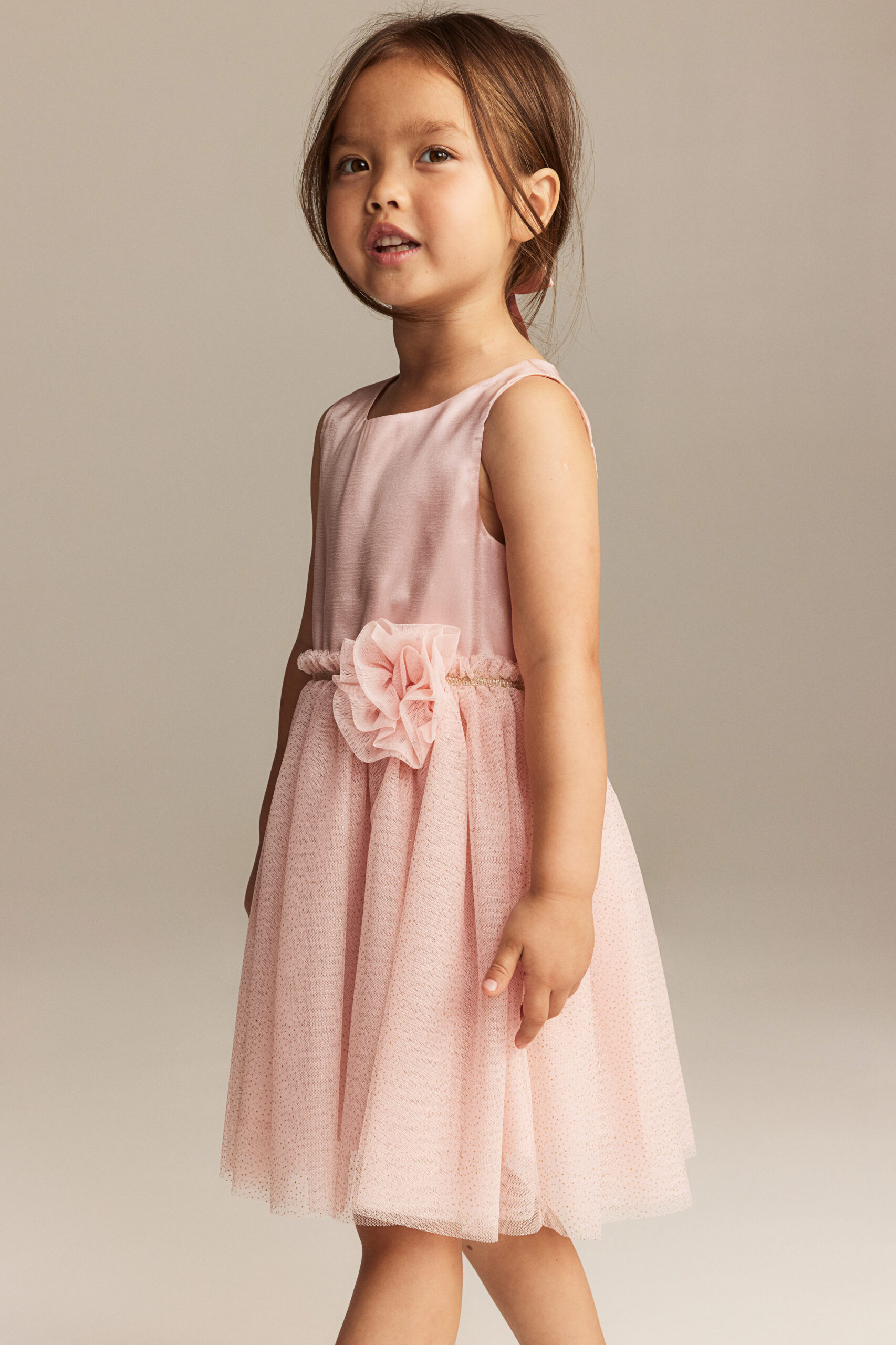 girl wearing pink dress with flower bow