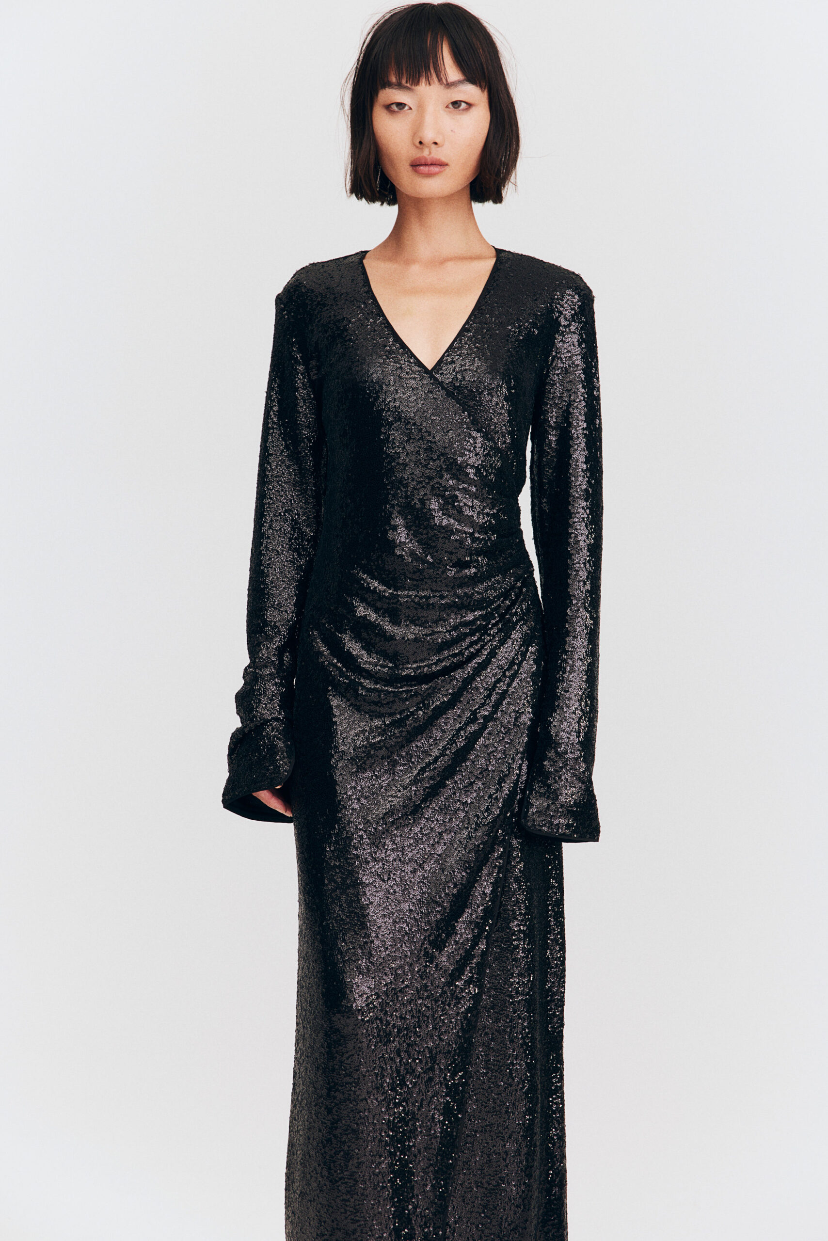 model wearing long black sparkly dress