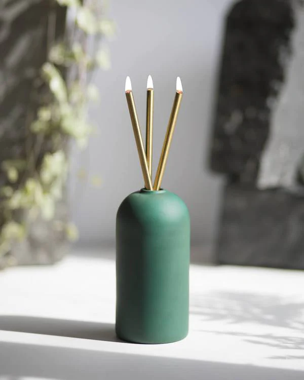 decorative candle in green vase