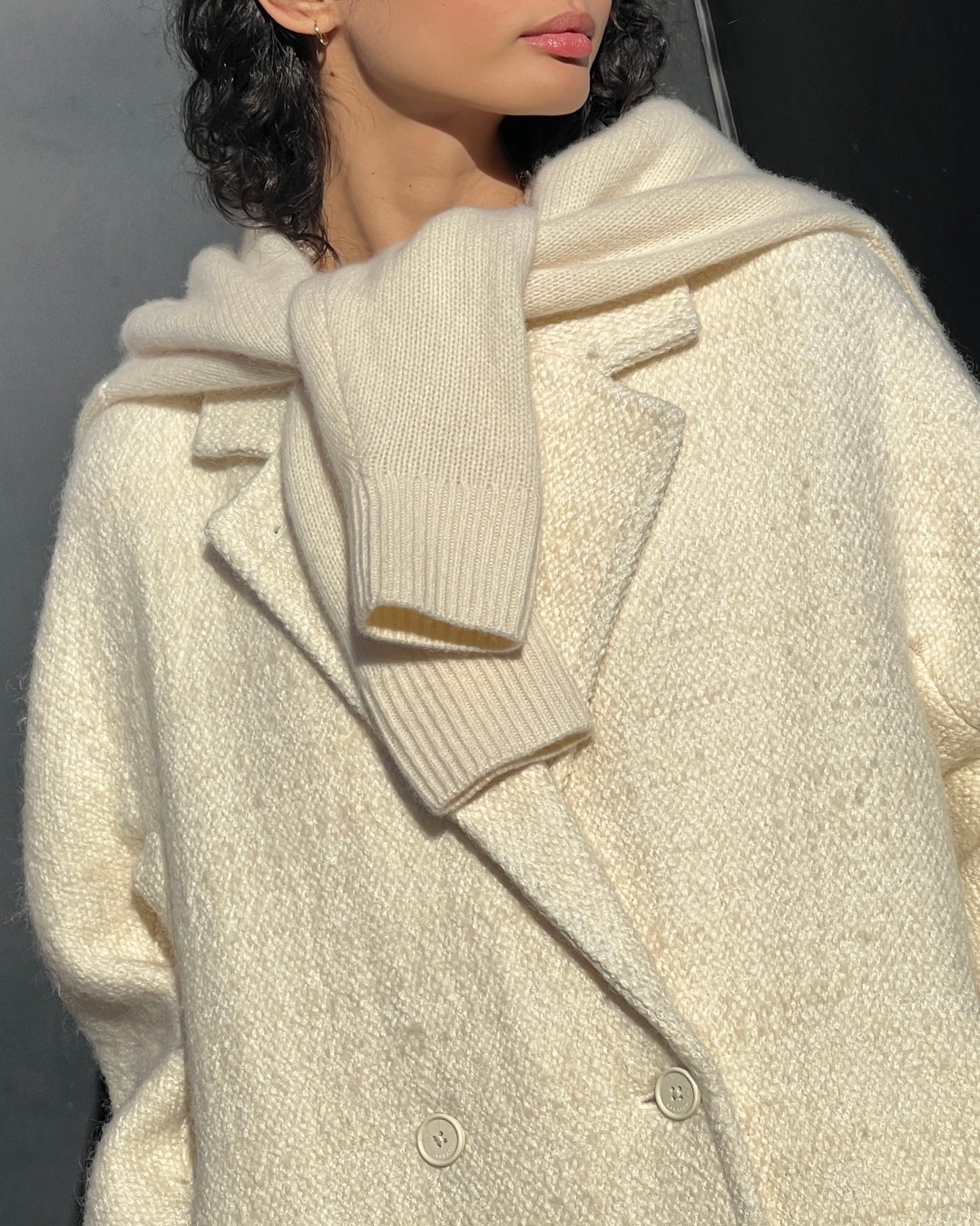 model wearing beige wool coat and sweater