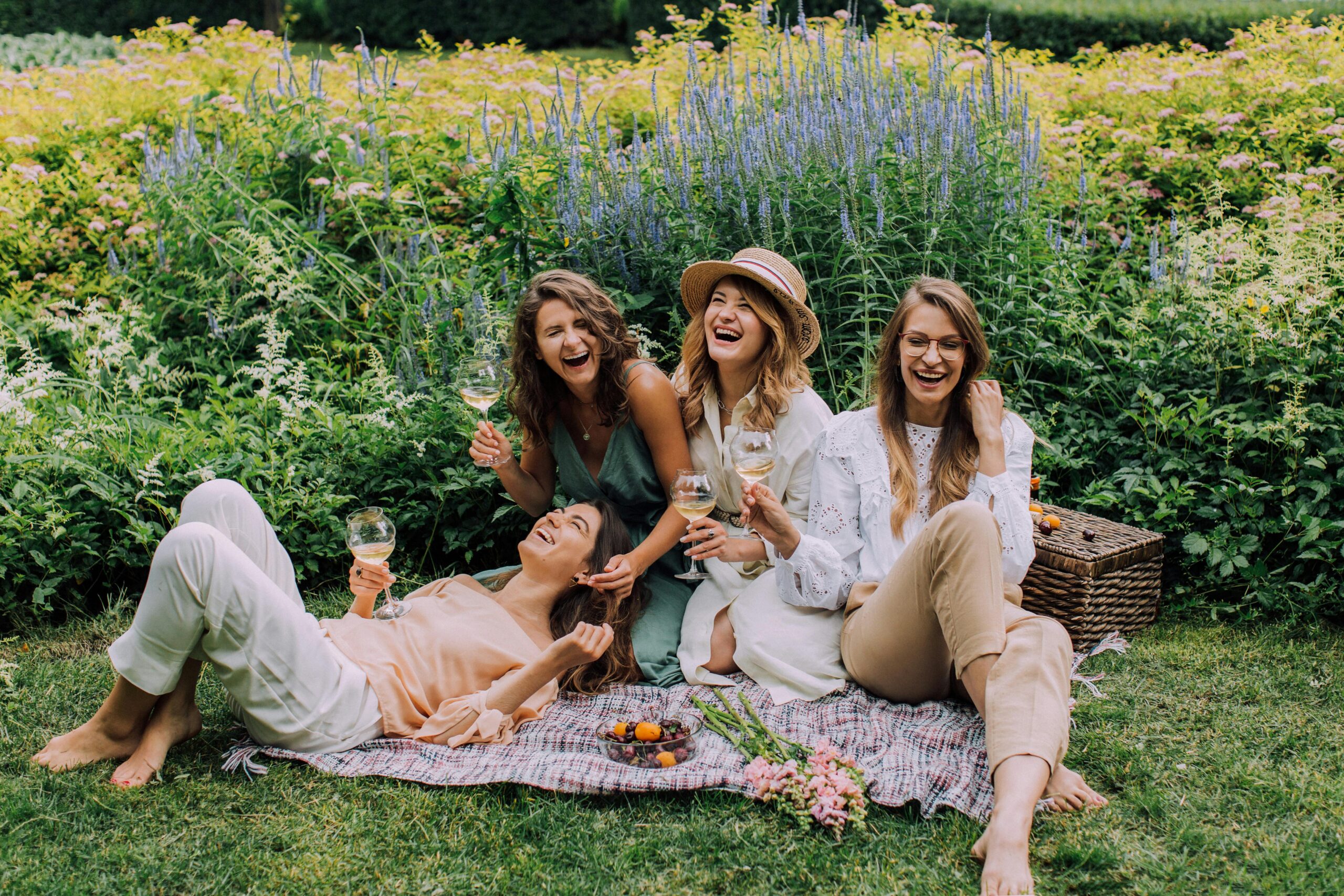 Four women wearing spring clothing on a picnic