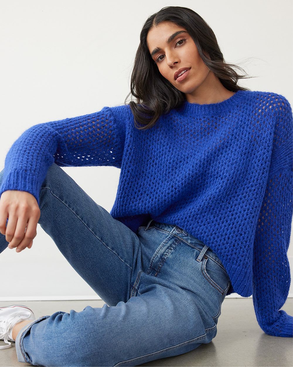 woman wearing blue knit sweater and jeans
