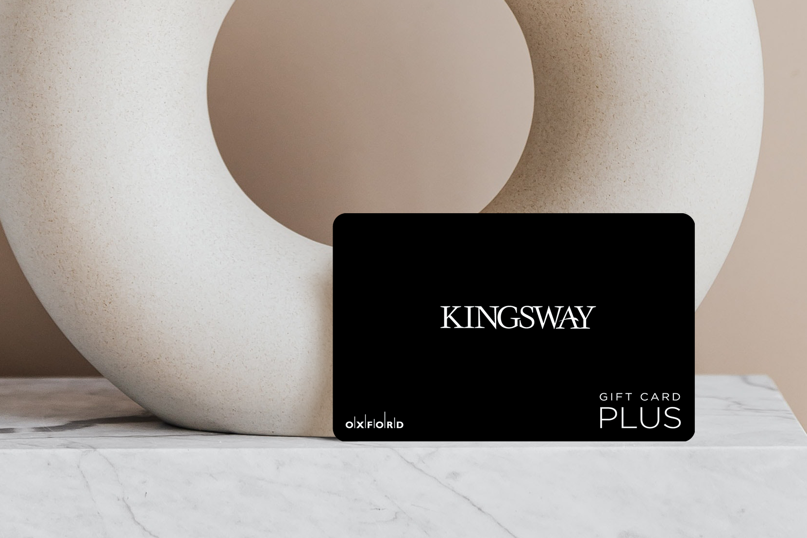 promotional image of a black kingsway gift card in front of a neutral circular vase