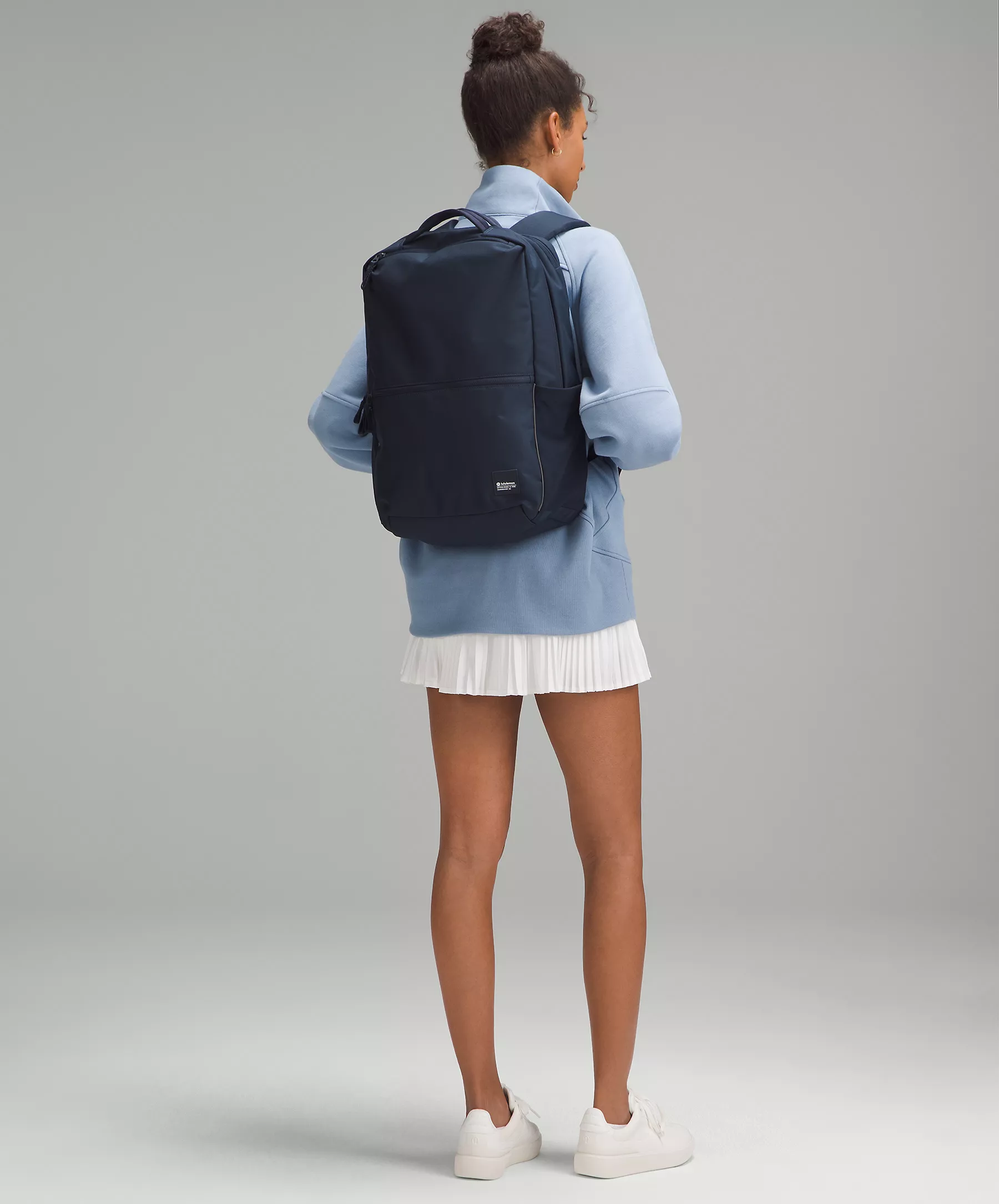 model wearing navy blue lululemon backpack