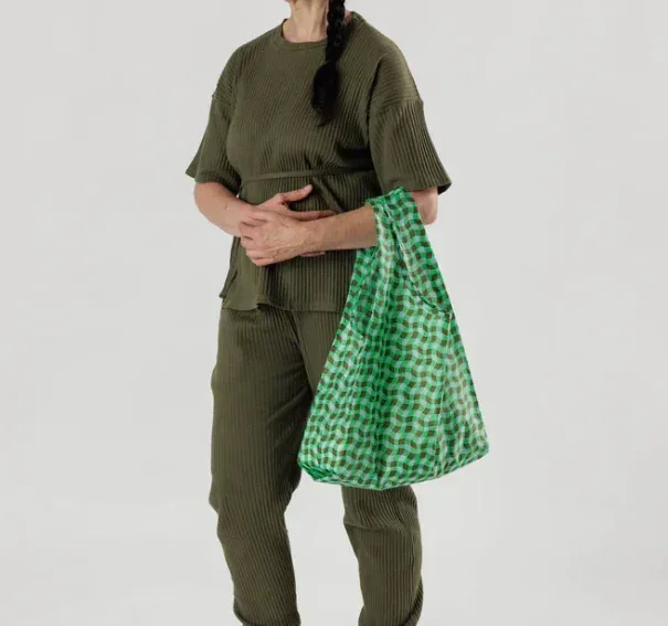 model holding green patterned reusable bag