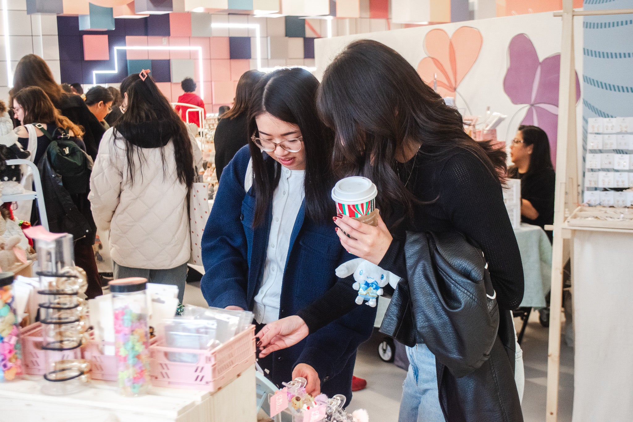 two females shopping at a vendor at Malla MRKT in Kingsway Mall