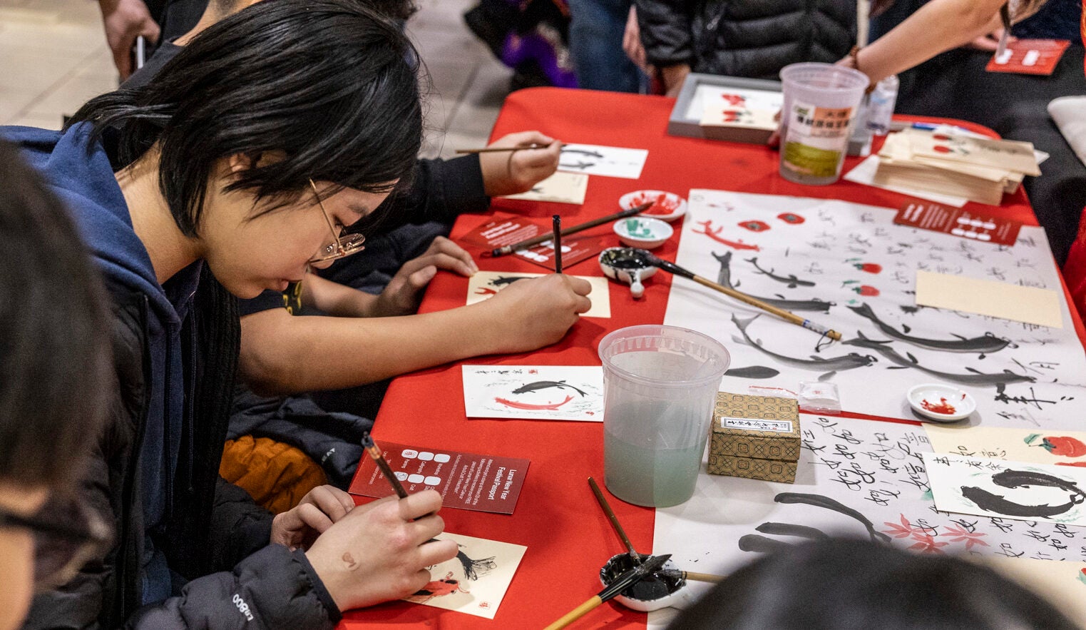 people painting Chinese style fish