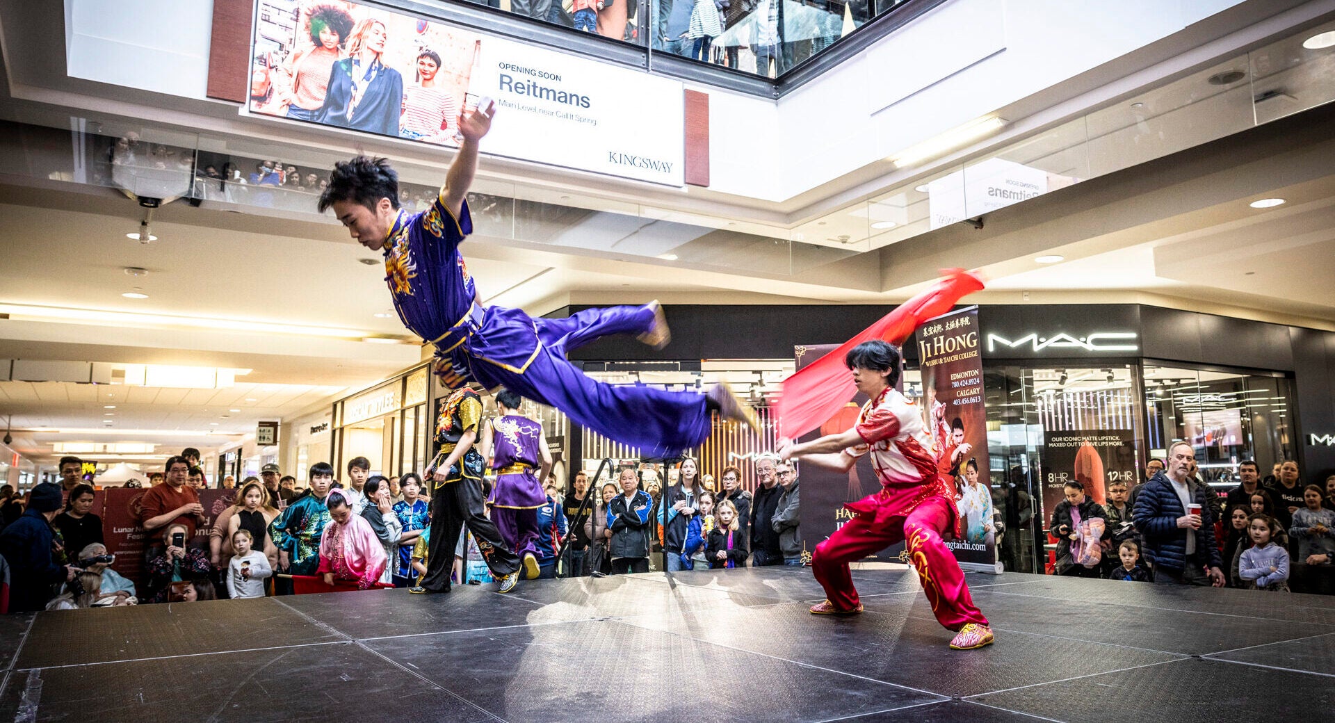 two men performing wushu on stage