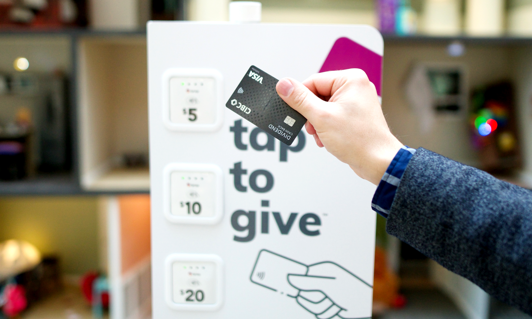 hand tapping credit card on donation station