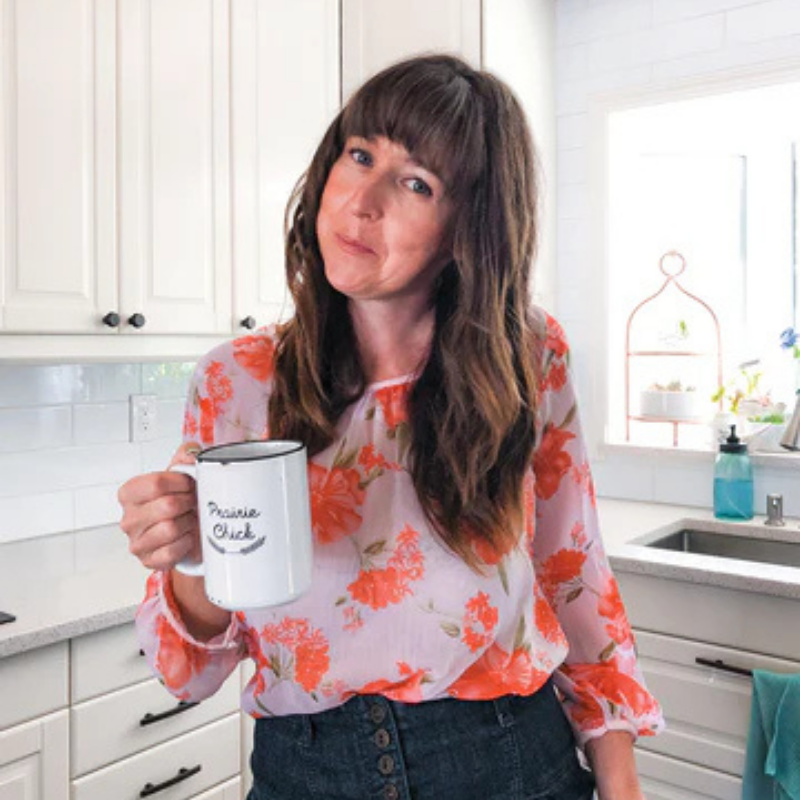 female business owner holding mug