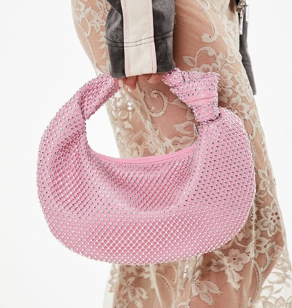 model holding pink round purse from Forever 21