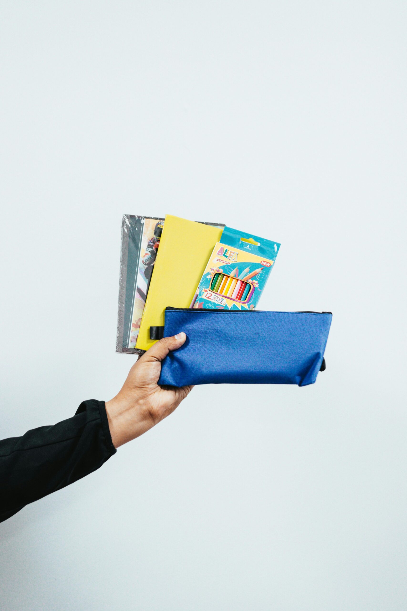 holding school supplies in hand
